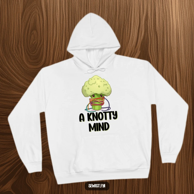 Funny hooded sweatshirt featuring a clumsy broccoli floret hilariously tangled in colorful sewing thread, cozy and humorous crafter attire.